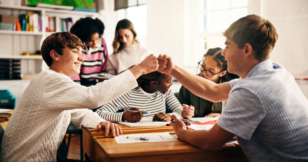 School Refusal and Re-Engagement Education, team and student in classroom with fist bump